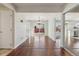 Bright living room with hardwood floors transitions to the kitchen with a sliding glass door to the backyard at 15614 E 51St Pl, Denver, CO 80239