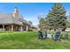 Expansive backyard featuring a well-manicured lawn, mature trees, and an outdoor seating area at 2500 Van Gordon St, Lakewood, CO 80215