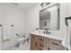 Updated bathroom featuring a sleek vanity, modern fixtures, and a well-lit mirror at 2500 Van Gordon St, Lakewood, CO 80215