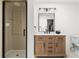Contemporary bathroom with walk-in shower and updated vanity with modern lighting at 2500 Van Gordon St, Lakewood, CO 80215