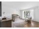 Bright Bedroom features a wooden crib, comfortable chair, and plenty of natural light at 2500 Van Gordon St, Lakewood, CO 80215