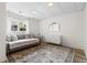 Charming bedroom featuring a daybed, neutral decor, and a cozy, patterned rug at 2500 Van Gordon St, Lakewood, CO 80215