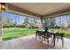 Covered patio with brick flooring and outdoor dining setup, perfect for entertaining at 2500 Van Gordon St, Lakewood, CO 80215
