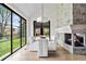 Elegant dining room with a fireplace, modern lighting, and large windows offering outdoor views at 2500 Van Gordon St, Lakewood, CO 80215