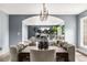 Dining room with a large table, modern chandelier, and an archway view into the living room at 2500 Van Gordon St, Lakewood, CO 80215
