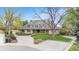 Charming single-Gathering home featuring a well-manicured front yard with a circular driveway and a welcoming porch at 2500 Van Gordon St, Lakewood, CO 80215
