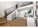 Bright foyer with an arched entryway and an ornamental iron staircase to the second floor at 2500 Van Gordon St, Lakewood, CO 80215