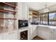 Cozy kitchen area with sleek appliances, stylish shelves, and convenient wine storage at 2500 Van Gordon St, Lakewood, CO 80215
