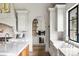 Bright kitchen featuring white cabinetry, stone countertops, and stainless steel appliances at 2500 Van Gordon St, Lakewood, CO 80215