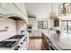 Bright kitchen features a large island, stone countertops, and professional grade appliances at 2500 Van Gordon St, Lakewood, CO 80215