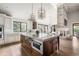 Open kitchen with a large island, stone fireplace, and an adjacent dining area at 2500 Van Gordon St, Lakewood, CO 80215