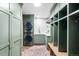 Well-organized laundry room with stacked washer/dryer and custom storage for efficient chores at 2500 Van Gordon St, Lakewood, CO 80215