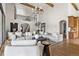 Large living room featuring high ceilings, exposed beams, and stylish, comfortable seating at 2500 Van Gordon St, Lakewood, CO 80215