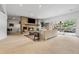 Bright living room with a brick fireplace, neutral furniture, and sliding glass doors to the patio at 2500 Van Gordon St, Lakewood, CO 80215