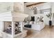 Bright living area featuring a stone fireplace, chandelier, and hardwood floors at 2500 Van Gordon St, Lakewood, CO 80215