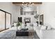 Bright and expansive living room with high ceilings, wood beams, and large windows for natural light at 2500 Van Gordon St, Lakewood, CO 80215