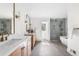 Contemporary main bathroom with double vanities, a soaking tub, and a glass-enclosed shower for relaxation at 2500 Van Gordon St, Lakewood, CO 80215