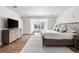 Spacious primary bedroom with large windows, hardwood floors, and a comfortable king-size bed at 2500 Van Gordon St, Lakewood, CO 80215
