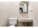 Elegant powder room with unique stone sink, modern fixtures, and sophisticated wall covering at 2500 Van Gordon St, Lakewood, CO 80215