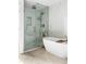 Luxurious bathroom featuring a glass shower and soaking tub with modern finishes for relaxation and comfort at 2500 Van Gordon St, Lakewood, CO 80215