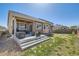 Landscaped backyard with a concrete patio and a well-maintained lawn perfect for outdoor enjoyment at 5181 Delphinium Cir, Brighton, CO 80601