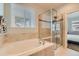 Bright bathroom boasting a soaking tub, and a separate glass enclosed walk-in shower with neutral colored walls at 5181 Delphinium Cir, Brighton, CO 80601