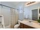 Functional bathroom featuring a vanity with a sink, a toilet, and a shower with a curtain in a cozy space at 5181 Delphinium Cir, Brighton, CO 80601