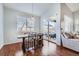 Elegant dining area with a modern table, chairs, pendant lighting, and a view to the backyard at 5181 Delphinium Cir, Brighton, CO 80601