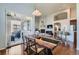 Open dining area with a modern table, chairs, and seamless flow to the living area and outdoor patio at 5181 Delphinium Cir, Brighton, CO 80601