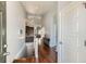 Inviting entryway with hardwood floors leading to a modern kitchen and staircase at 5181 Delphinium Cir, Brighton, CO 80601