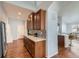 Stylish kitchen featuring wooden cabinets, tiled backsplash, and modern countertops, seamlessly connecting to the dining area at 5181 Delphinium Cir, Brighton, CO 80601