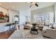 Spacious living room with hardwood floors, a large window, and comfortable seating at 5181 Delphinium Cir, Brighton, CO 80601