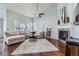 Cozy living room featuring a fireplace, vaulted ceilings, and comfortable seating at 5181 Delphinium Cir, Brighton, CO 80601
