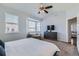 Spacious main bedroom featuring a cozy sitting area, a ceiling fan, and neutral tones for a tranquil retreat at 5181 Delphinium Cir, Brighton, CO 80601