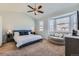 Serene main bedroom with vaulted ceilings, comfortable seating area, and bright natural light from large windows at 5181 Delphinium Cir, Brighton, CO 80601