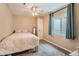Bedroom with tan walls, carpeted floors, and a window. There is a door and a mirror against the wall at 6302 S Jackson Gap Ct, Aurora, CO 80016