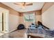 This bedroom includes light hardwood floors, a ceiling fan, a single window, and an inviting beanbag chair at 6302 S Jackson Gap Ct, Aurora, CO 80016