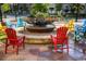 Inviting common area with colorful Adirondack chairs surrounding a unique fire pit and landscaping at 6302 S Jackson Gap Ct, Aurora, CO 80016