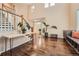 Sunlit foyer with gleaming hardwood floors, an elegant staircase and access to the house at 6302 S Jackson Gap Ct, Aurora, CO 80016