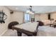 Finished basement with a pool table and comfortable seating, illuminated by an elegant chandelier at 6302 S Jackson Gap Ct, Aurora, CO 80016
