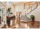 Bright and spacious living room featuring hardwood floors, staircase and a two-story high ceiling at 6302 S Jackson Gap Ct, Aurora, CO 80016