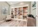 Cozy office space with a built-in bookshelf and a chair near a window at 6302 S Jackson Gap Ct, Aurora, CO 80016