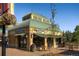 Exterior of a Worlds Pretzels store with outdoor seating and a brick facade at 6302 S Jackson Gap Ct, Aurora, CO 80016