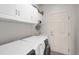 Laundry room with washer, dryer, and cabinets at 10682 W Indore Dr, Littleton, CO 80127