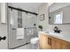 Bathroom featuring a glass door shower, contemporary finishes, and a stylish vanity at 10930 W Tulane Ave, Littleton, CO 80127