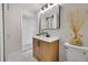 Bathroom featuring wood cabinet, black hardware, contemporary finishes and a decorative mirror at 10930 W Tulane Ave, Littleton, CO 80127