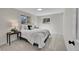 Bedroom featuring neutral paint, carpet, updated light fixtures, and dual windows at 10930 W Tulane Ave, Littleton, CO 80127