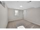 A carpeted bedroom featuring a window letting in light, and a flush ceiling light and an open doorway at 10930 W Tulane Ave, Littleton, CO 80127