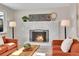 Close up of the living room fireplace, featuring cozy seating, and a stylish modern mantle at 10930 W Tulane Ave, Littleton, CO 80127