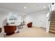 Finished basement with neutral color scheme, modern furniture, and a staircase leading to the upper level at 4227 Mariposa St, Denver, CO 80211